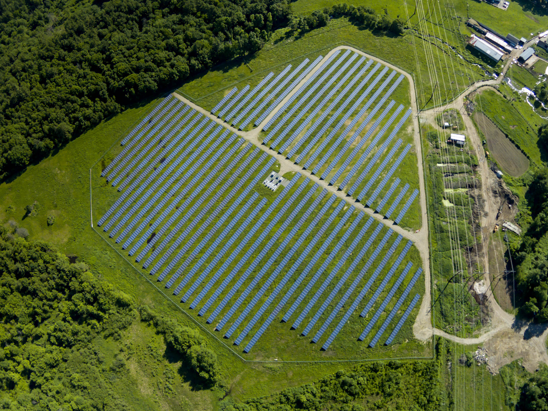 High above a landowner lease solar farm below